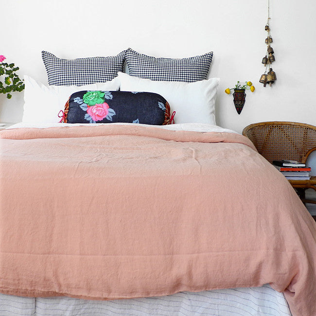 A Linge Particulier Linen Duvet in Copper gives a salmon and pink color to this duvet for a colorful linen bedding look from Collyer's Mansion