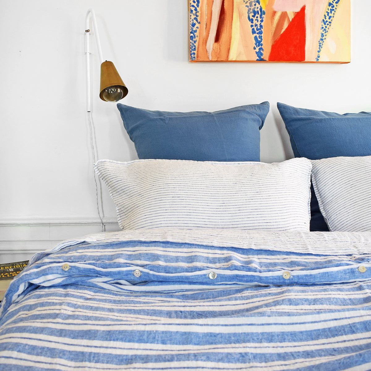 A Linge Particulier Linen Duvet in Large Blue Stripes gives a blue and white stripe color to this duvet for a colorful patterned and printed linen bedding look from Collyer's Mansion