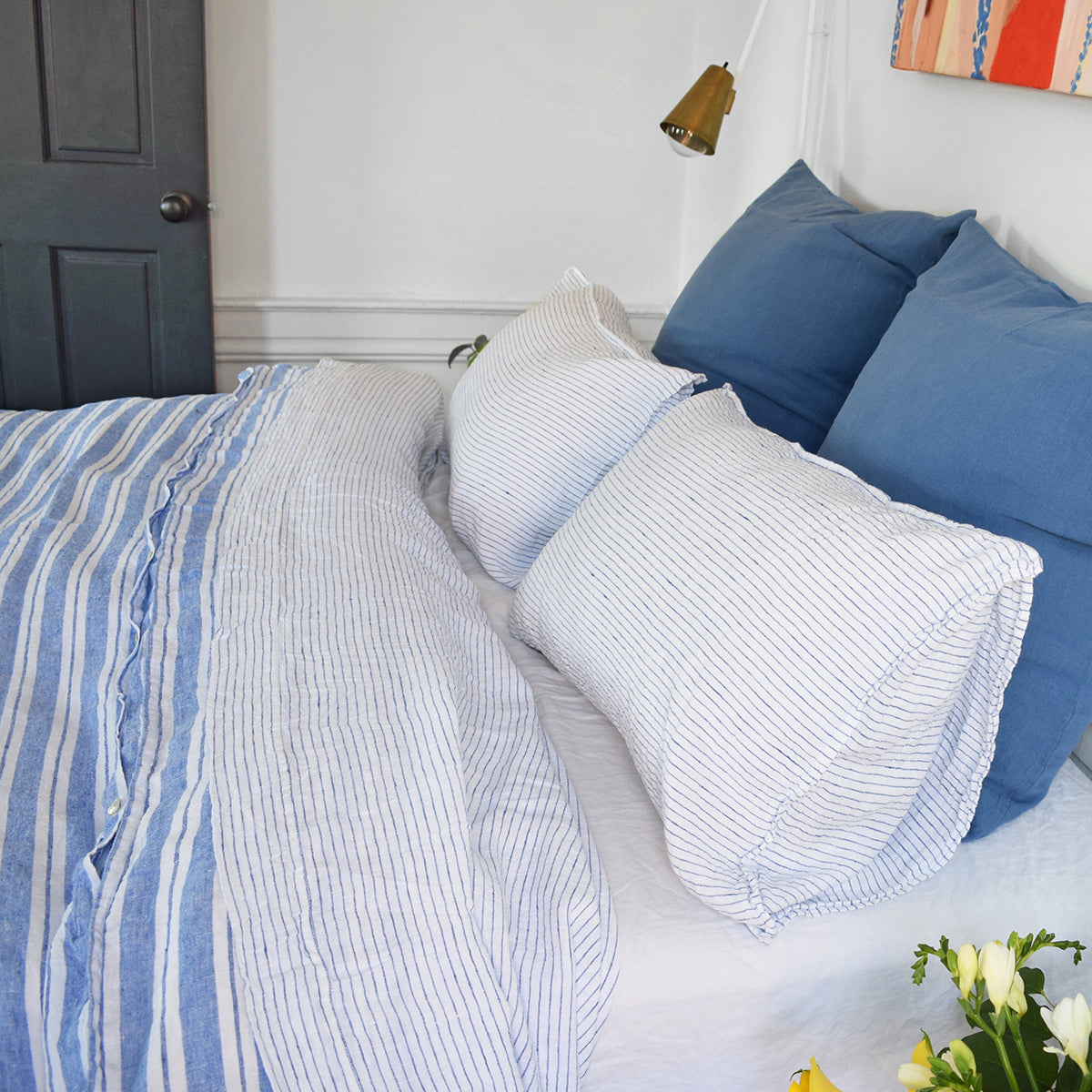 A Linge Particulier Linen Duvet in Large Blue Stripes gives a blue and white stripe color to this duvet for a colorful patterned and printed linen bedding look from Collyer's Mansion